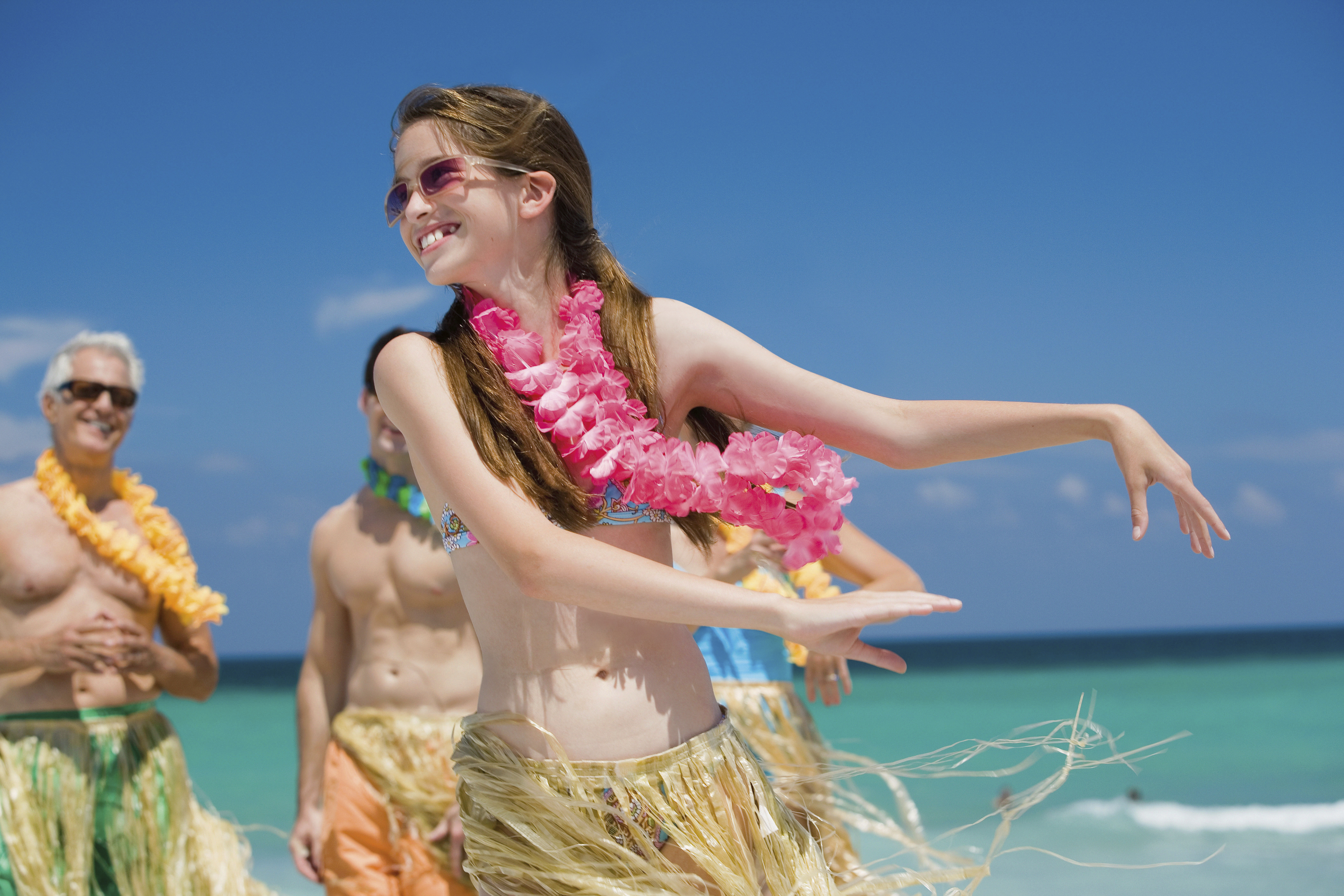 Girl hula dancing on a beach in Hawaii