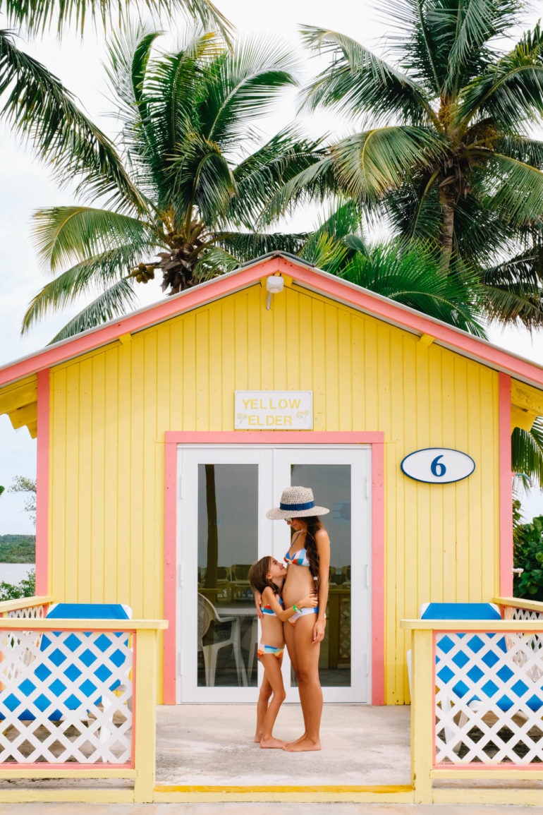 Drea and daughter hugging in front yellow bungalow