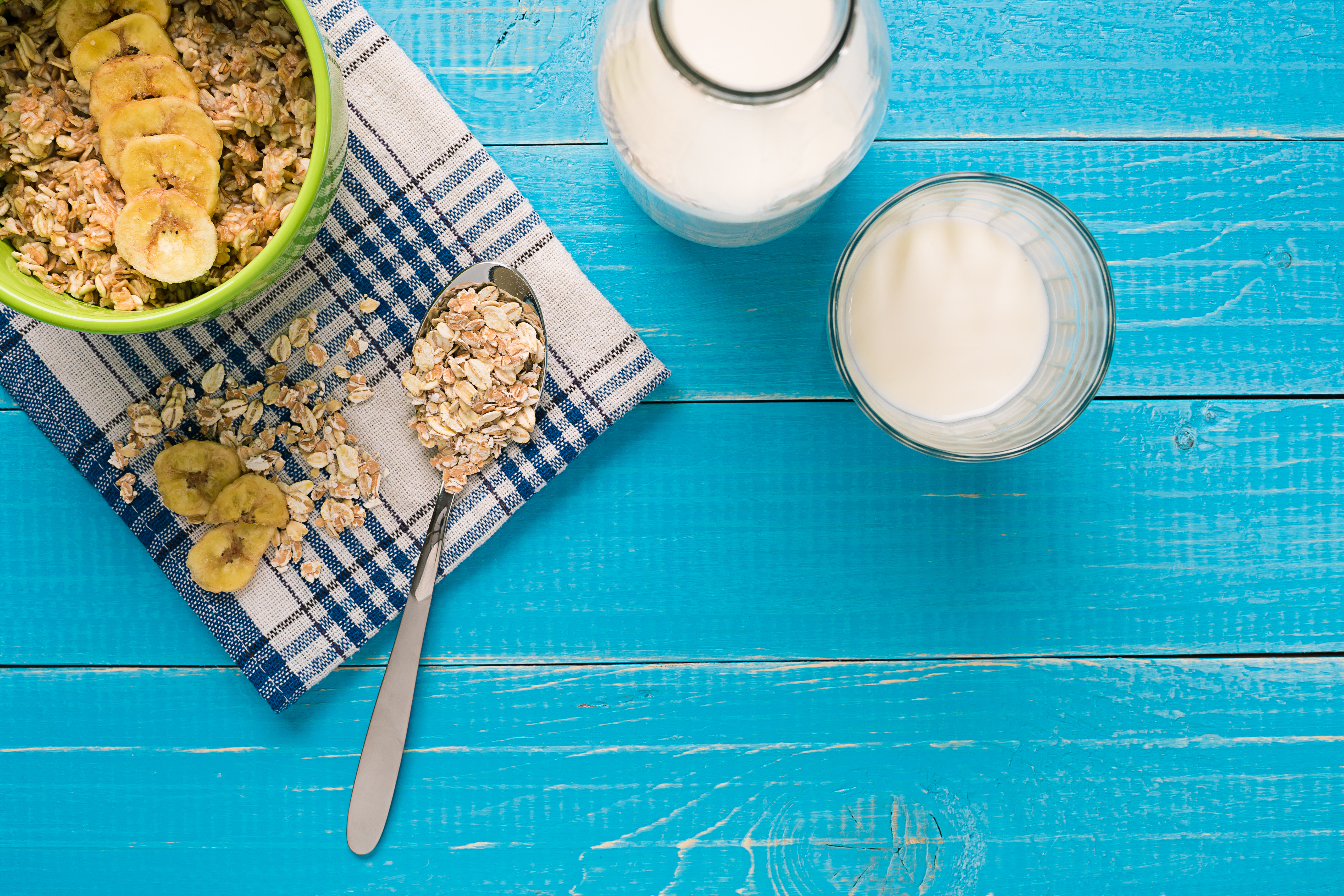 Porridge, oats, milk and banana on the table