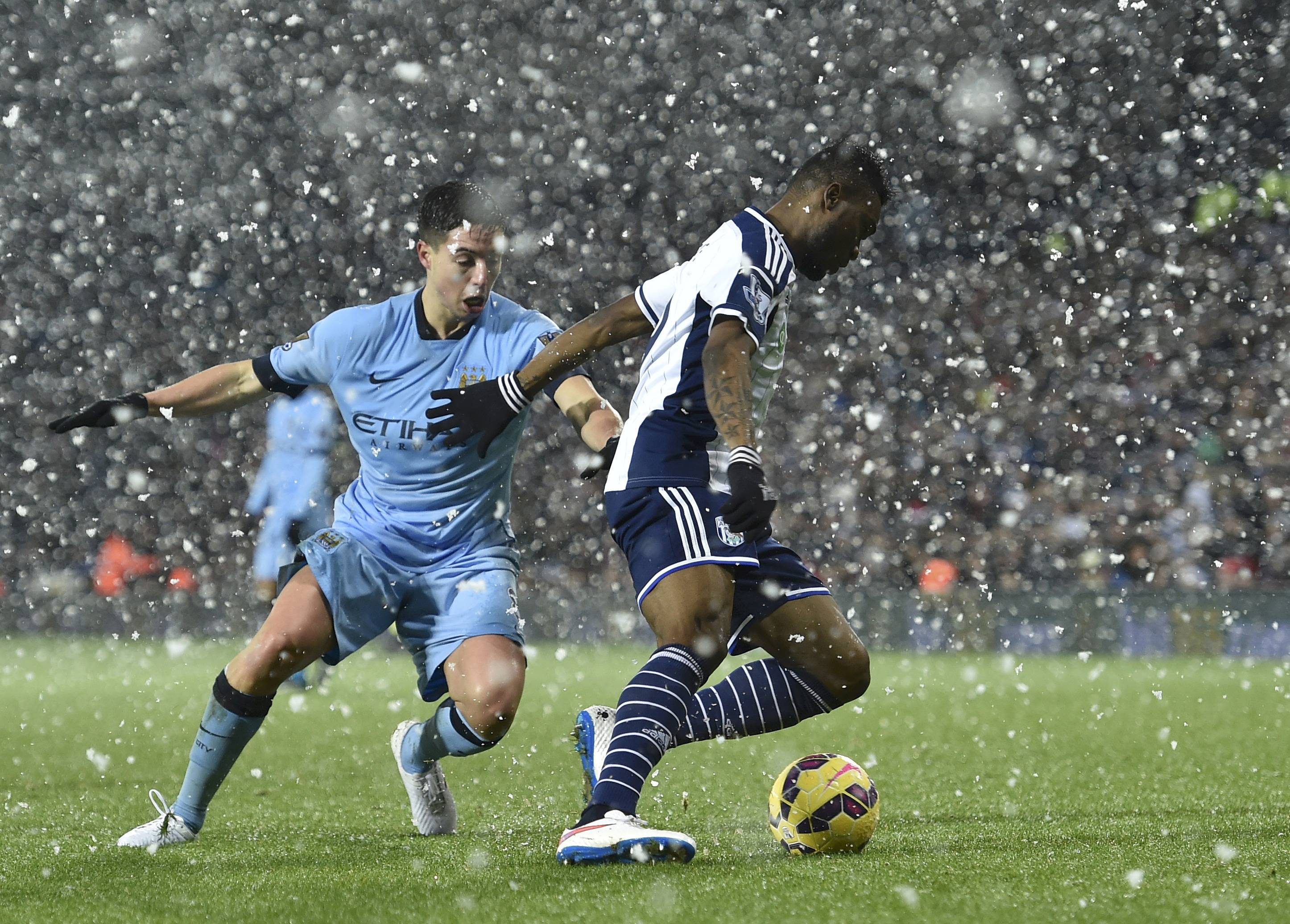 Manchester City's Samir Nasri challenges West Bromwich Albion's Brown Ideye during the English Premier League soccer match at The Hawthorns in West Bromwich