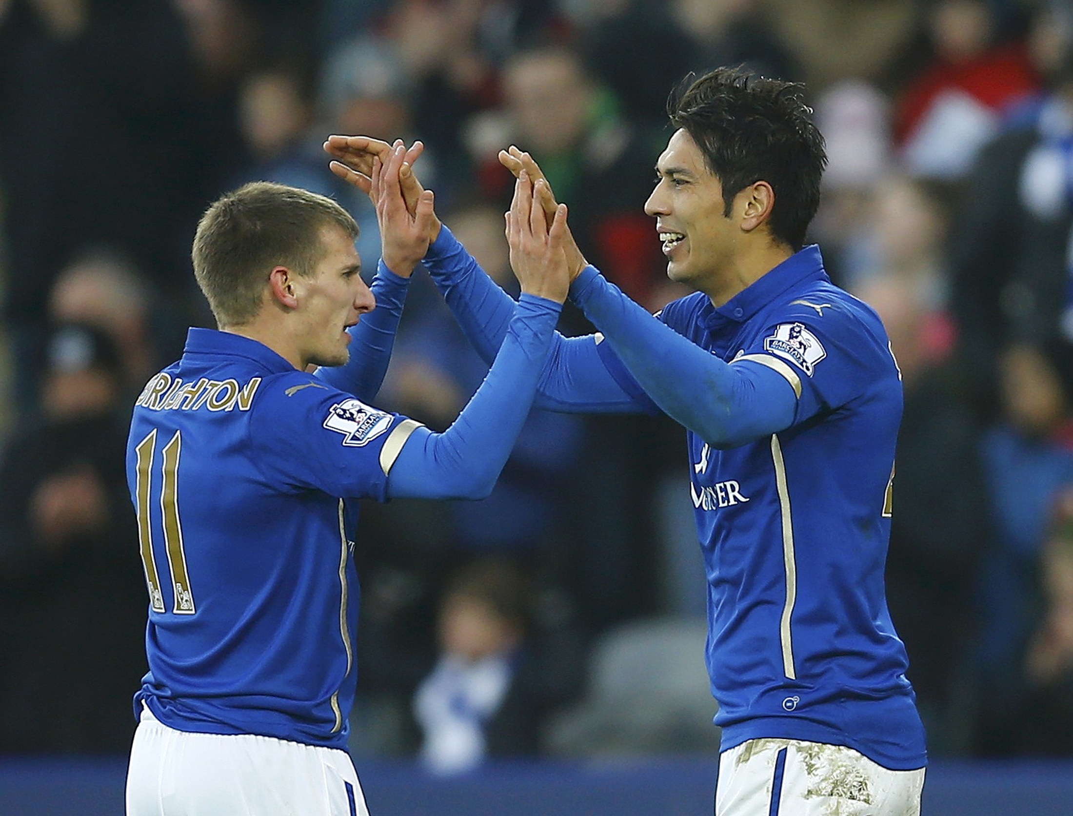 Leonardo Ulloa of Leicester City celebrates with team mate Wes Morgan after scoring against Newcastle United during their FA Cup third round soccer match at the King Power Stadium, in Leicester, central England